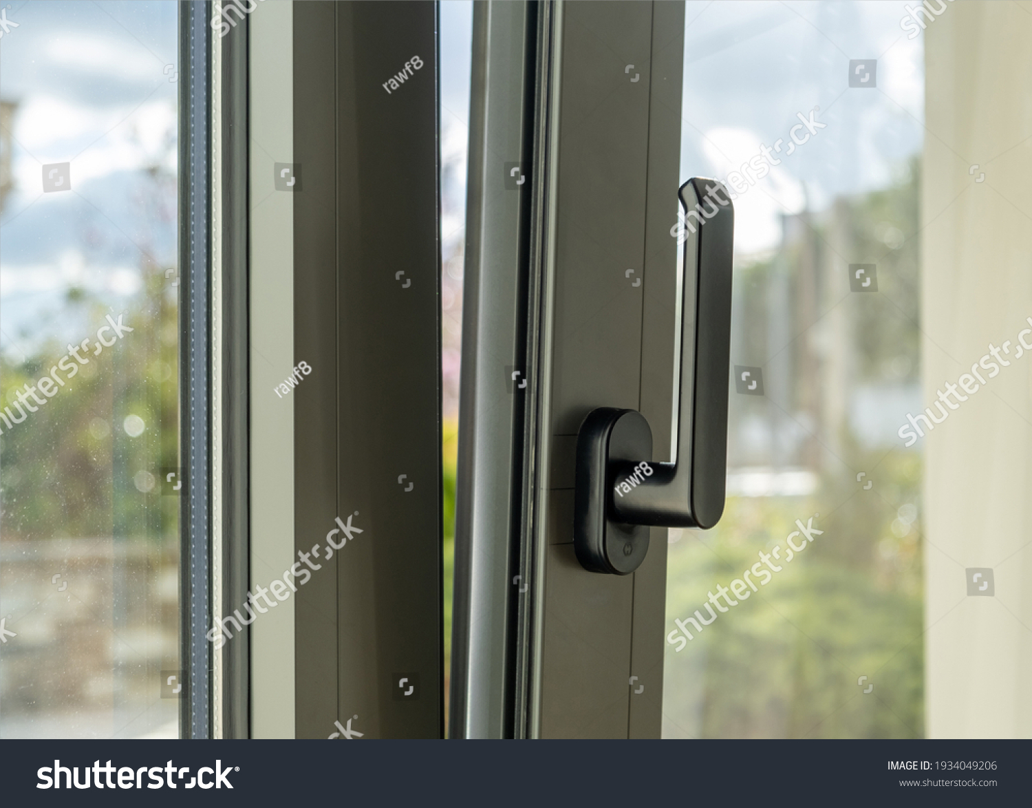Metal or PVC window vertical open closeup view. Tilt and turn grey color aluminum window, fresh air for home. Energy efficient, security profile metal door frame. #1934049206