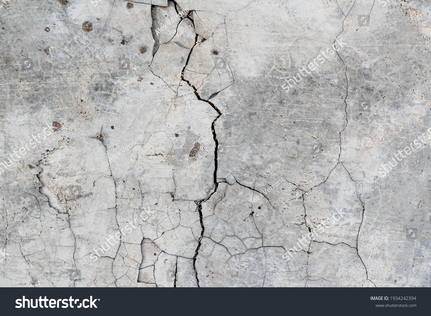 Cracked concrete. Concrete texture with cracks. Gray asphalt. The old texture is broken. #1934242394