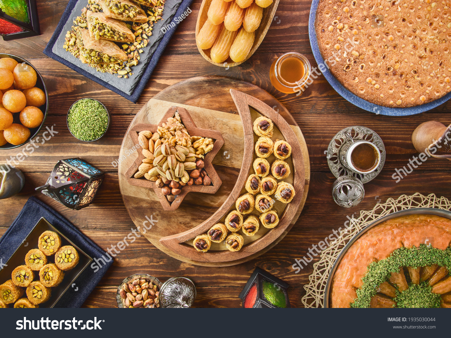 Arabic Cuisine: Middle Eastern desserts. Delicious collection of Ramadan traditional desserts. Served with tasty nuts, Arabic coffee, honey syrup and sugar syrup .Top view with close up. #1935030044