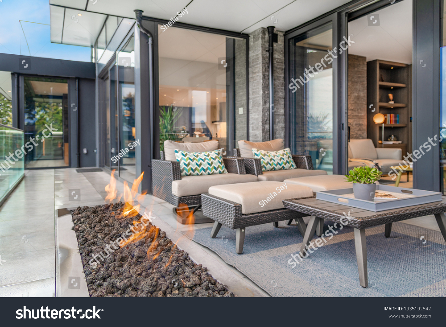 Exterior deck with large open gas fire #1935192542