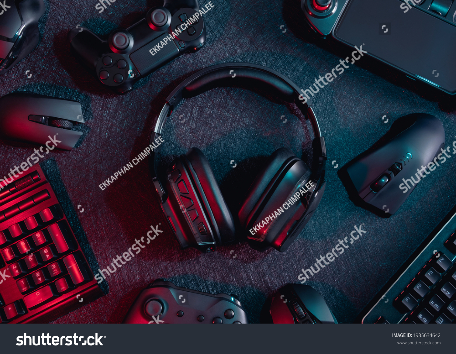gamer work space concept, top view a gaming gear, mouse, keyboard, joystick, headset with rgb color on black table background. #1935634642