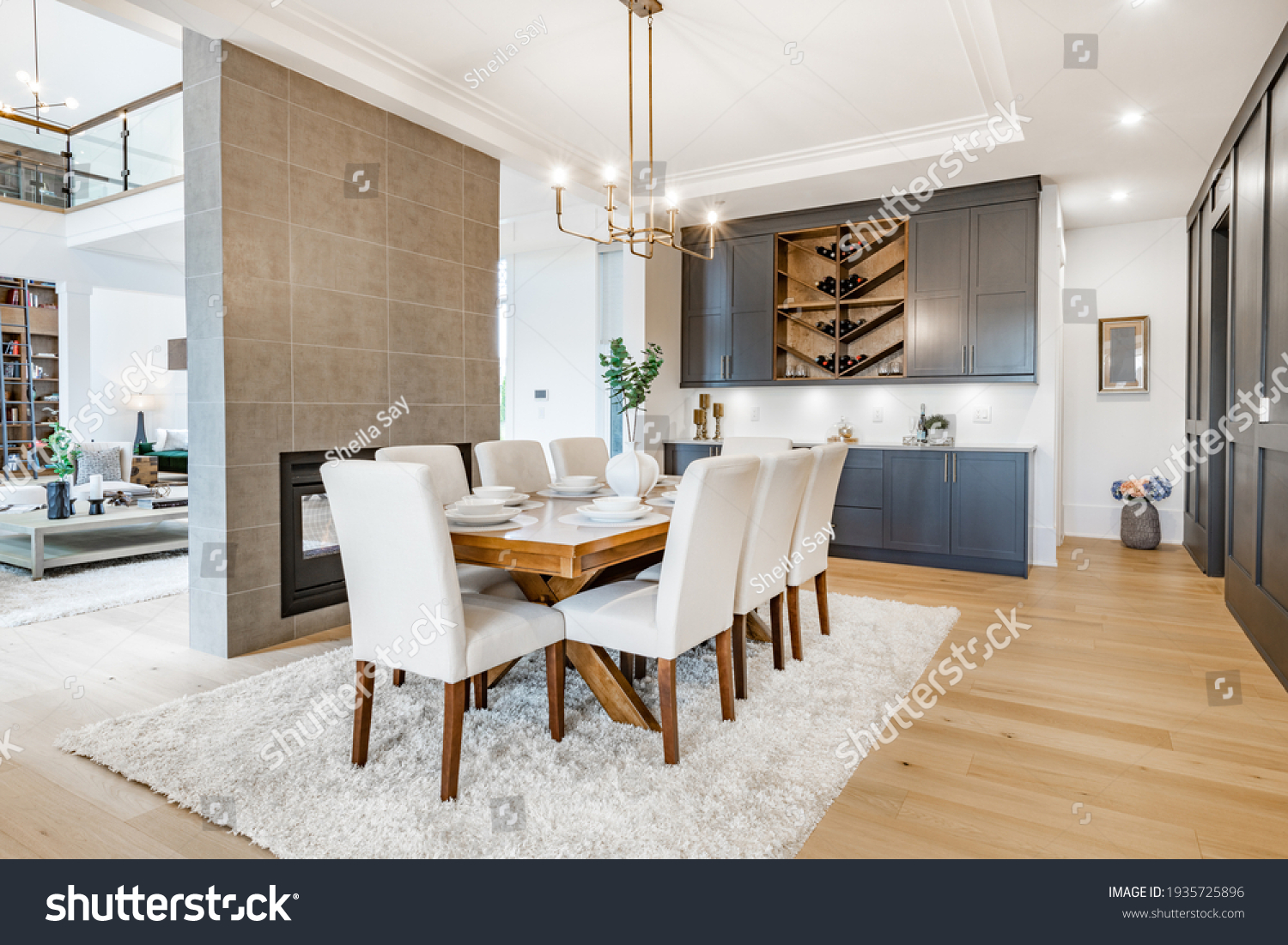 Elegant and large staged dining room with dark cabinets and walls. #1935725896