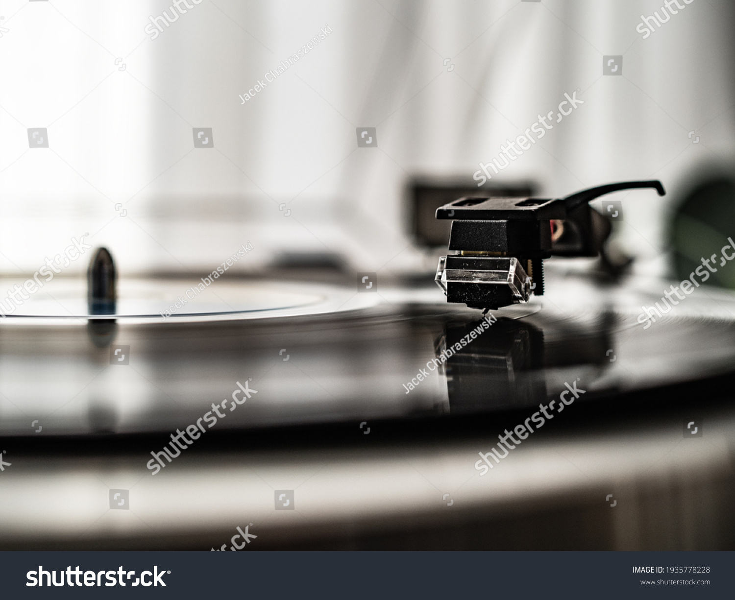 Turntable plays a vinyl record  #1935778228