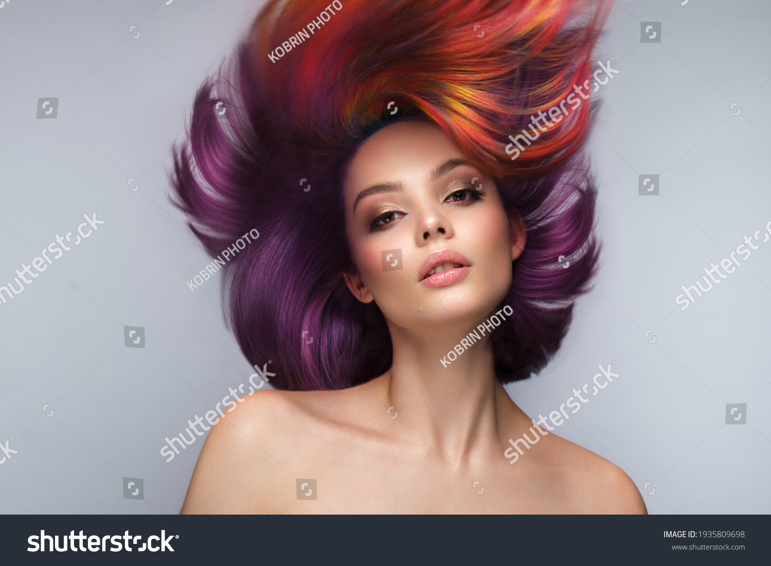 Beautiful woman with multi-colored hair and creative make up and hairstyle. Beauty face. #1935809698