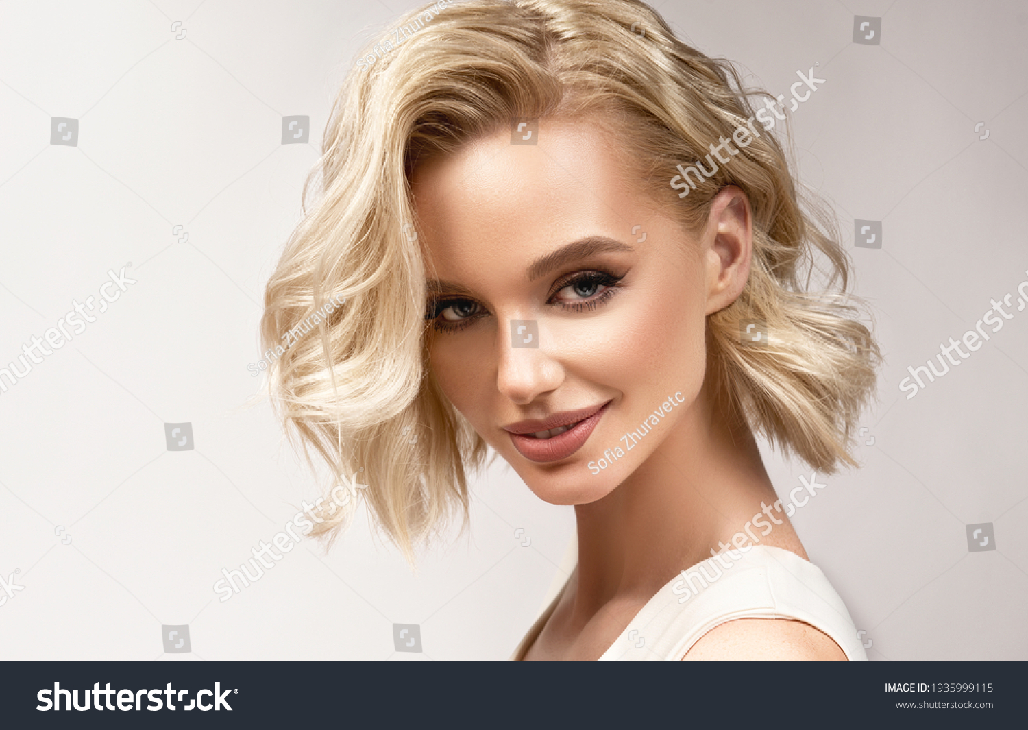 Beautiful model girl with short hair .Beauty woman with blonde curly hairstyle dye .Fashion, cosmetics and makeup #1935999115