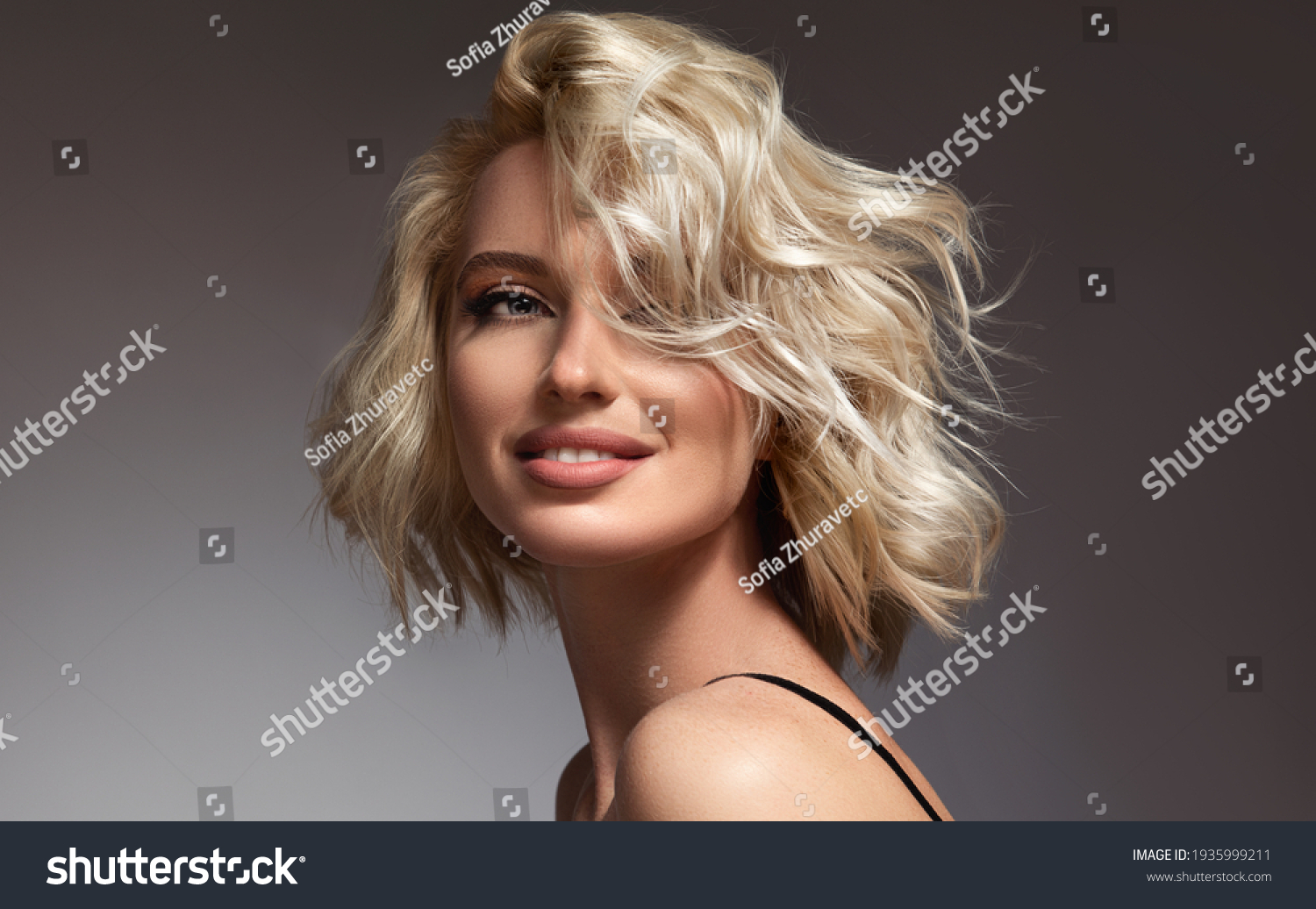 Beautiful model girl with short hair .Beauty  smiling woman with blonde curly hairstyle dye .Fashion, cosmetics and makeup #1935999211