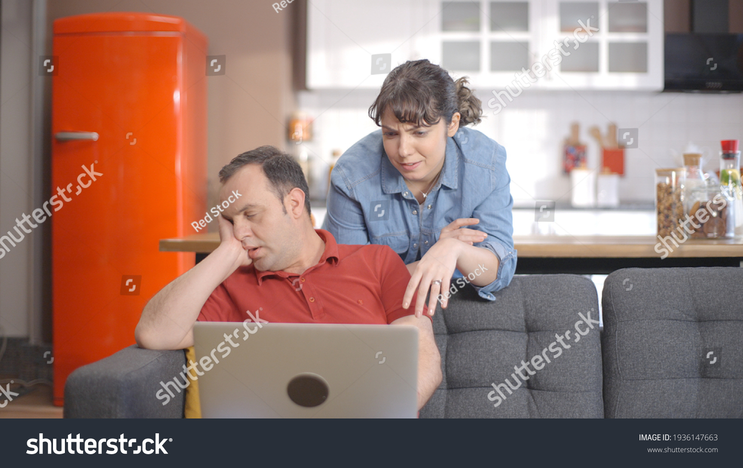 Young couple is shopping online from the computer. A young couple browsing online shopping sites looking for products. Online shopping concept.  #1936147663