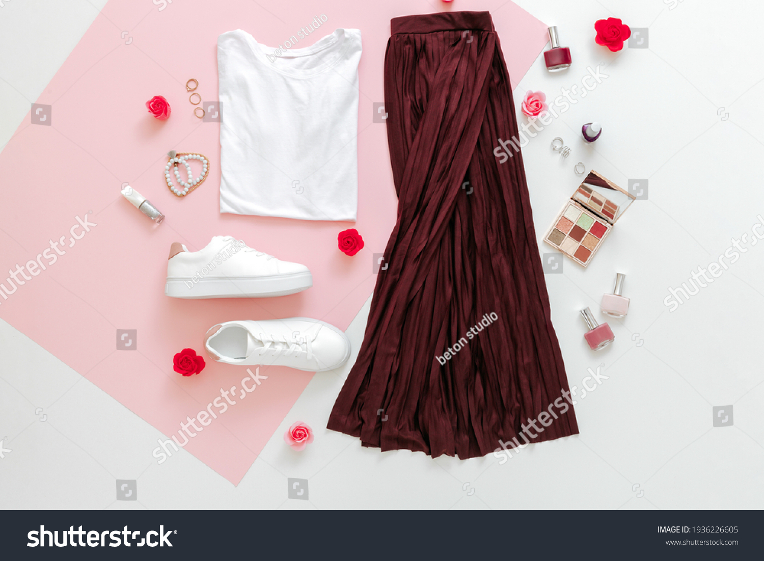 Folded clothes for women fashion urban basic outfit with accessories flowers make up cosmetics on pink background.Female spring look summer outfit skirt shoes sneakers basic tshirt bag. Top view. #1936226605