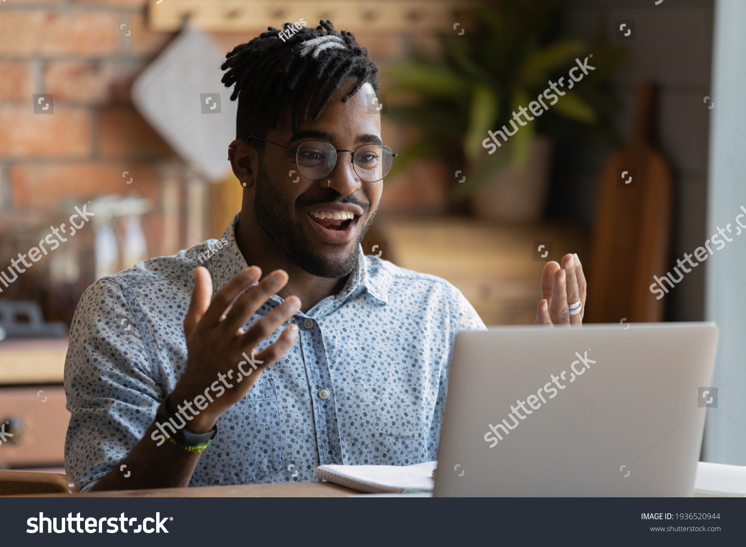 Happy young afro american man software developer run program code on pc enjoy reaching successful result. Overjoyed black guy look on laptop screen splash hands having winning hand at online blackjack #1936520944