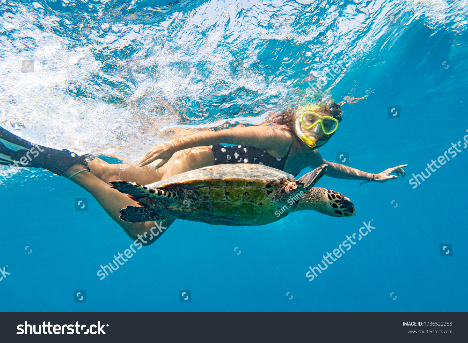Snorkeling with a sea turtle. Girl swimming with a mask next to the turtle, Maldives #1936522258