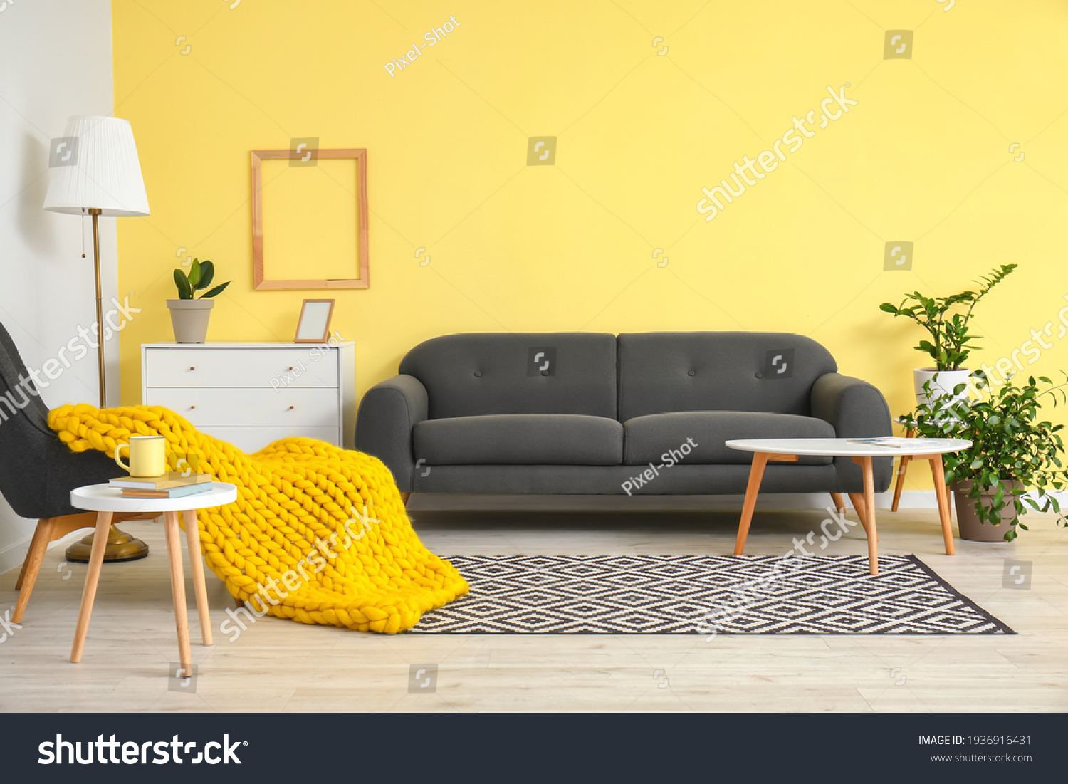 Interior of modern room with sofa, armchair and knitted plaid #1936916431
