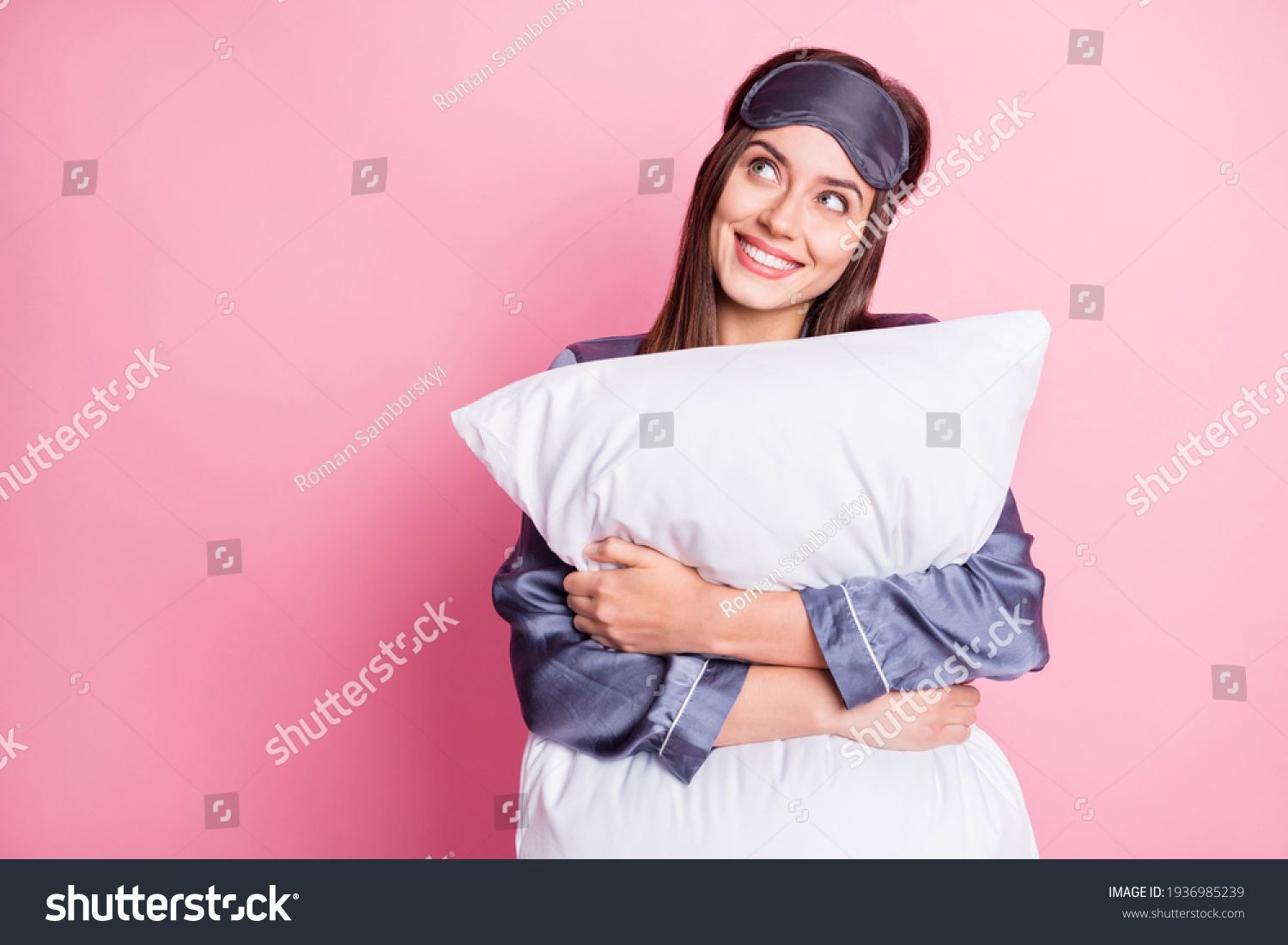 Photo portrait of dreamy girl hugging pillow looking at blank space isolated on pastel pink colored background #1936985239