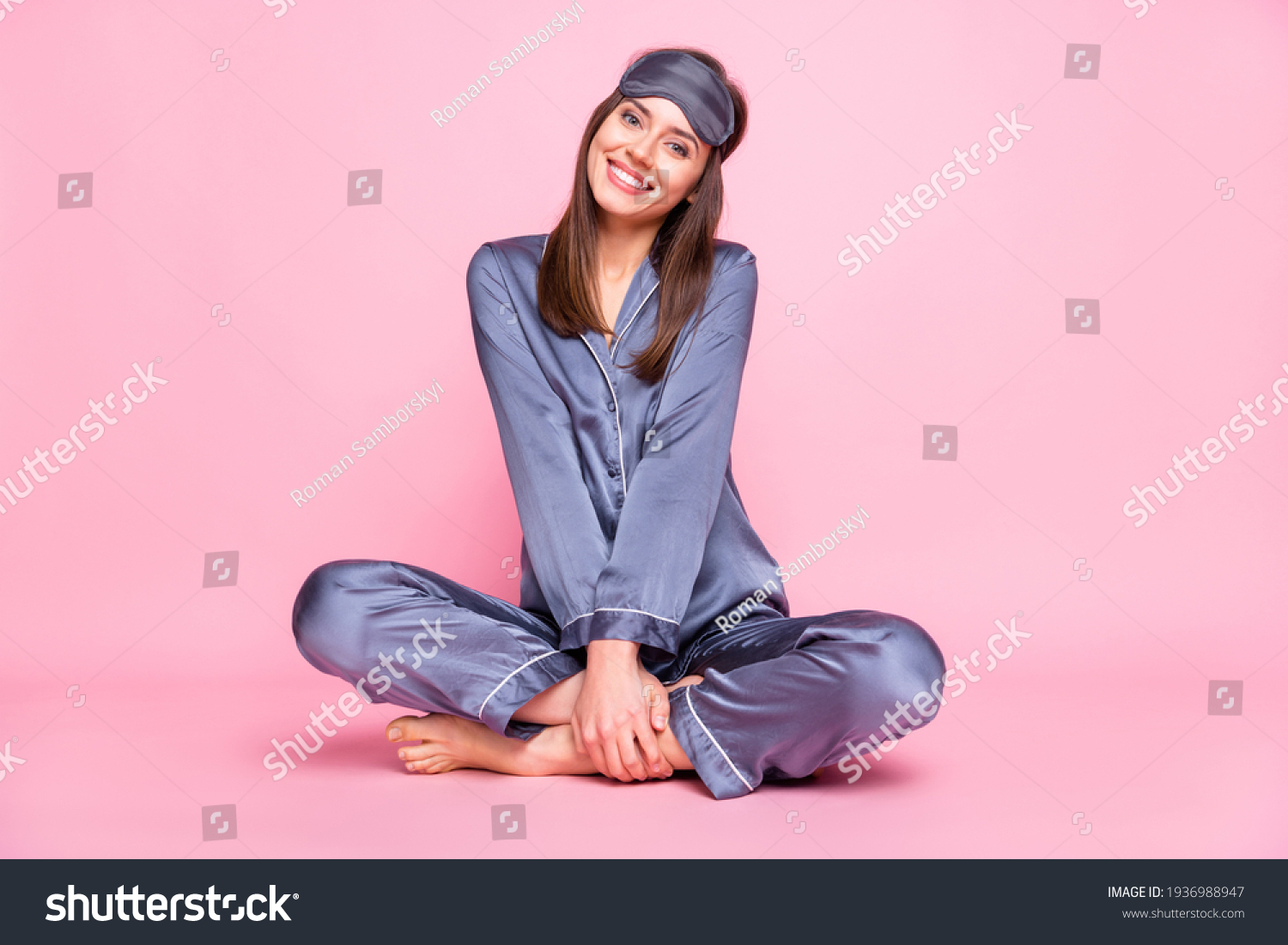 Full length photo portrait of cute girl sitting in lotus pose isolated on pastel pink colored background #1936988947