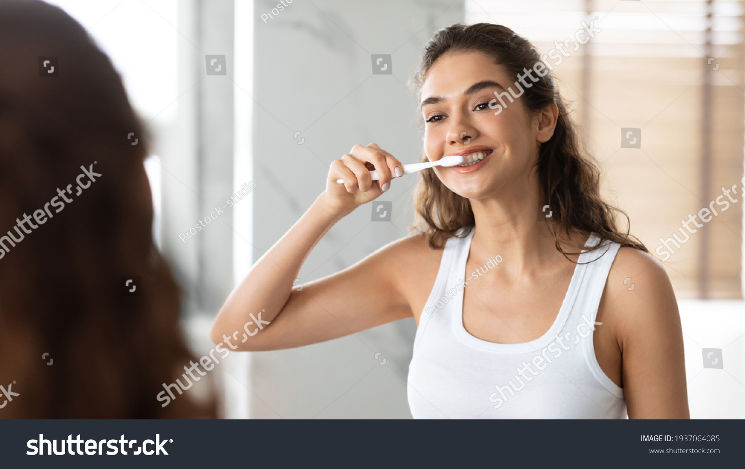 Happy Lady Brushing Teeth With Toothbrush Standing In Bathroom Indoor #1937064085