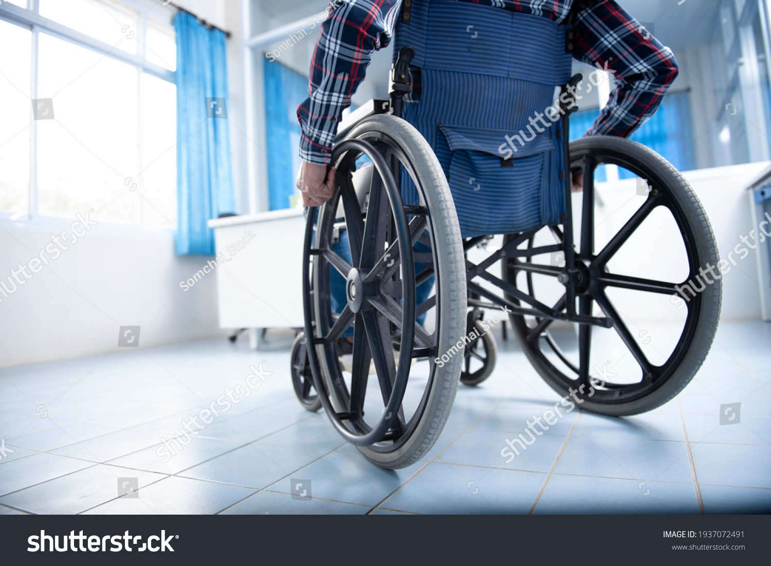 A disabled man on a wheelchair in the office Young man with disabilities in Asia. A man on a wheelchair Recovery and health care ideas Teamwork in Office #1937072491