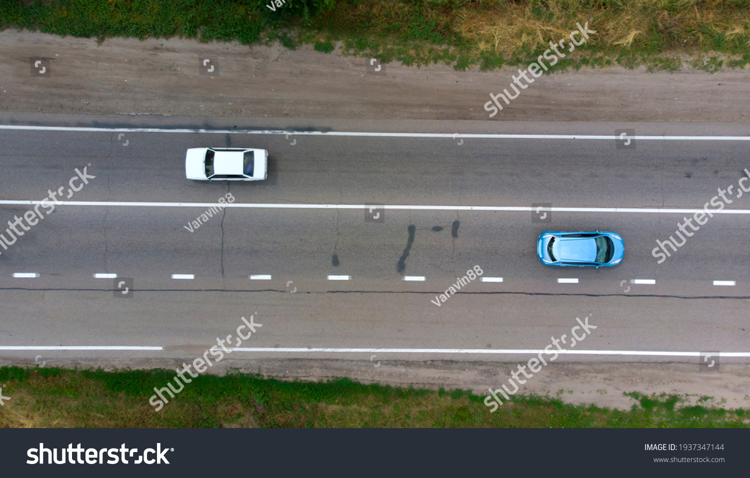 Aerial. Two sedan cars driving by the highway. Top view from drone.  #1937347144