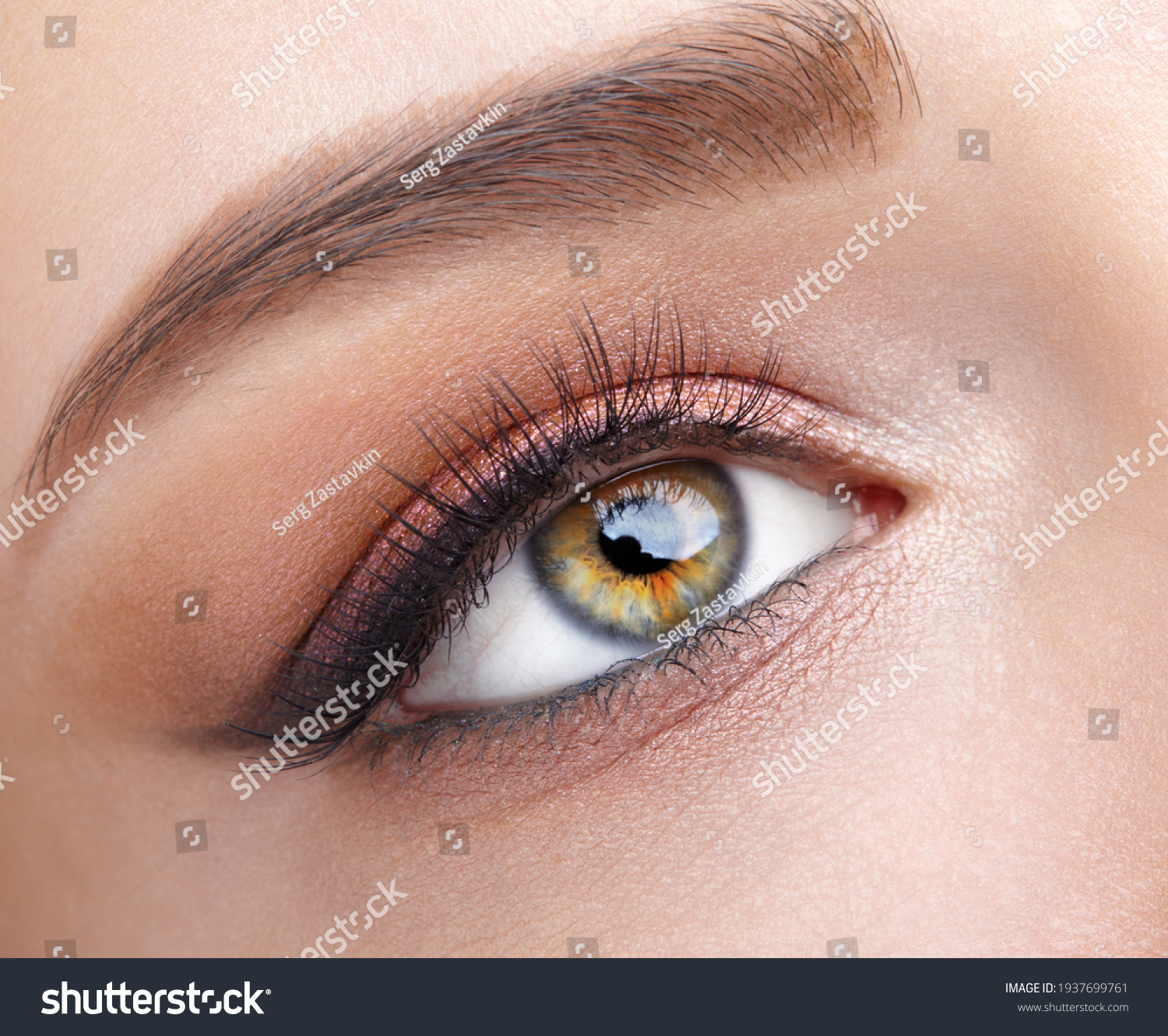 Closeup macro shot of  human female eye. Woman with natural evening vogue eye beauty makeup. Girl with perfect skin and  pink  eyes shadows. #1937699761
