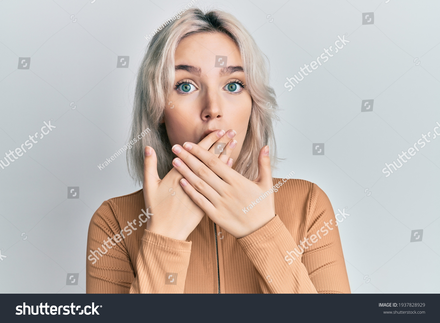 Young blonde girl wearing casual clothes shocked covering mouth with hands for mistake. secret concept.  #1937828929