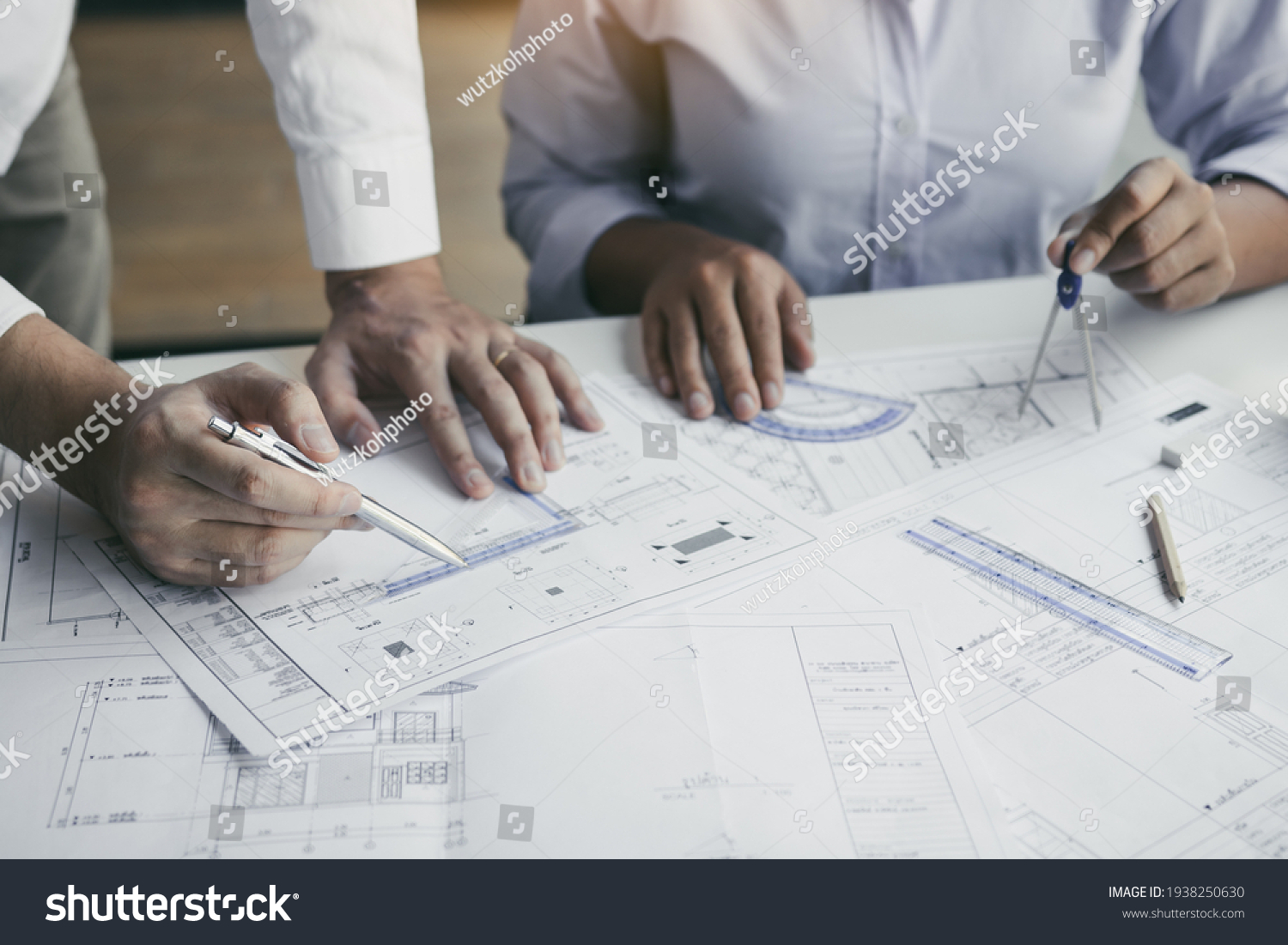The partnership engineering man or co-workers working on a project and discussing together with looking at blueprint paperwork. #1938250630