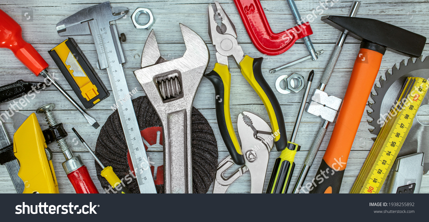 various renovation instruments and tools on grey background. screwdrivers, clamps, wrenches, keys top view #1938255892