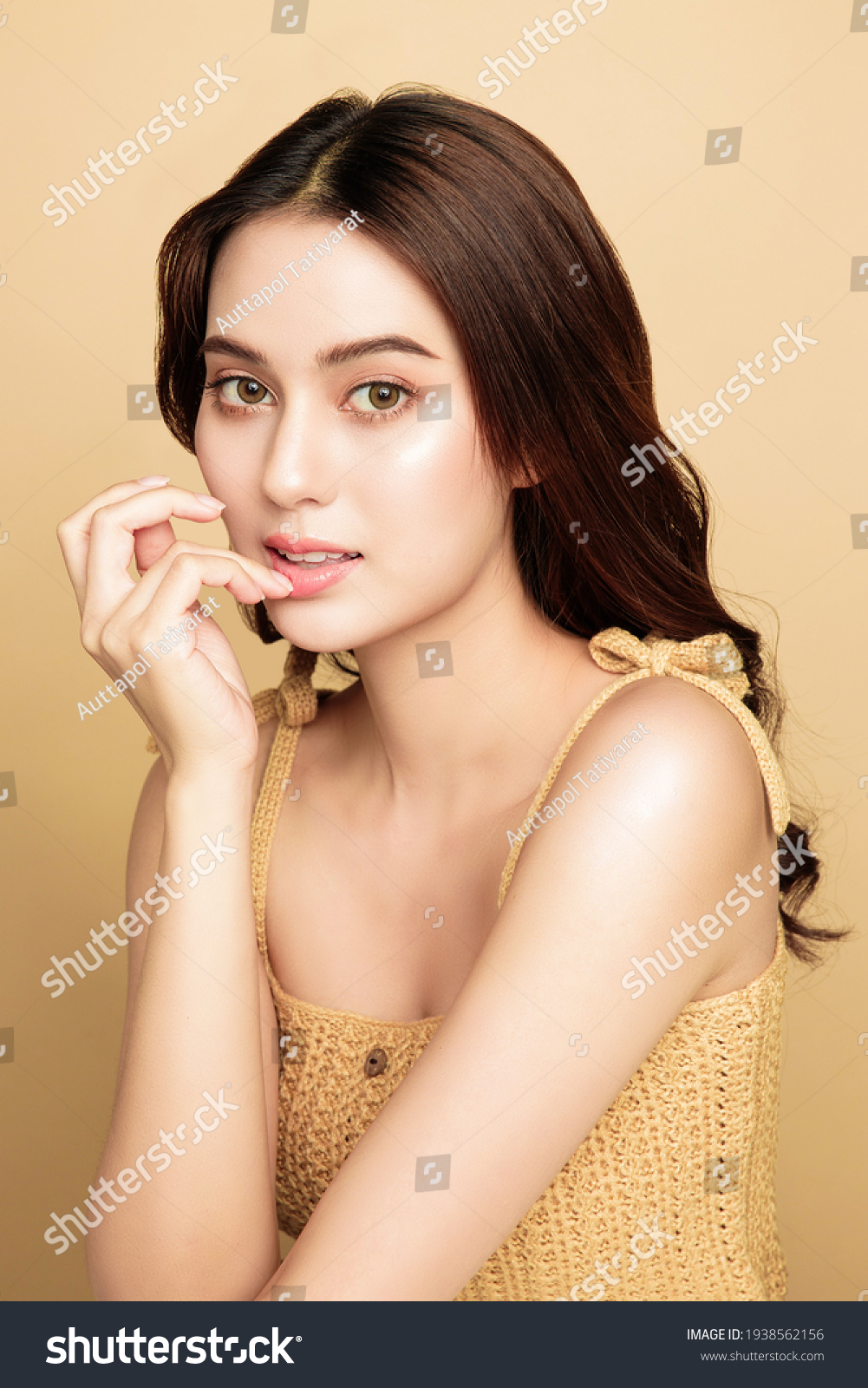 Asian woman are happy with perfect clean healthy skin and beautiful long brown hair. Cute female model clean fresh skin. Expressive facial expressions. Cosmetology concept. #1938562156