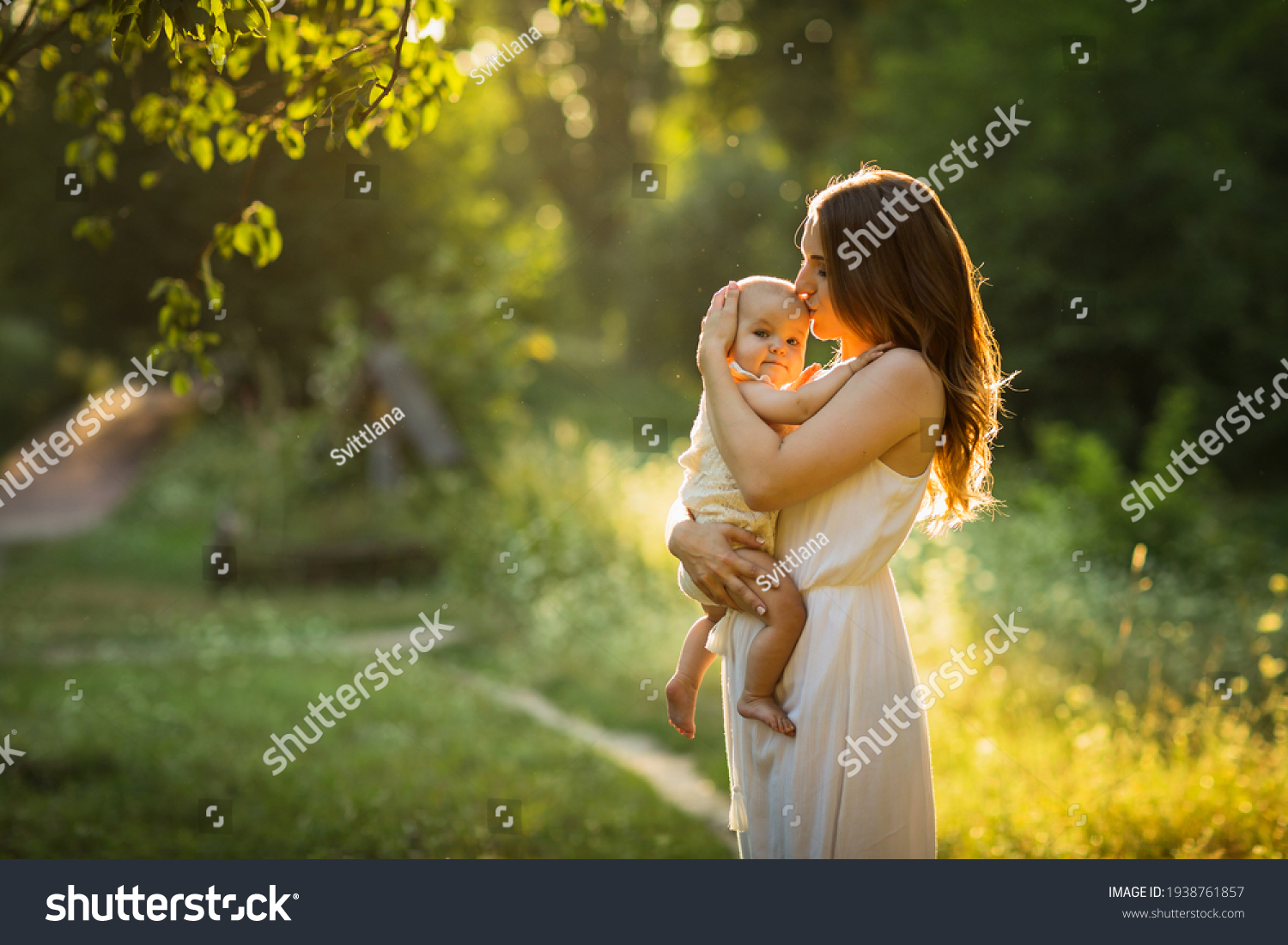 Young beautiful mother plays with her child outdoor. #1938761857