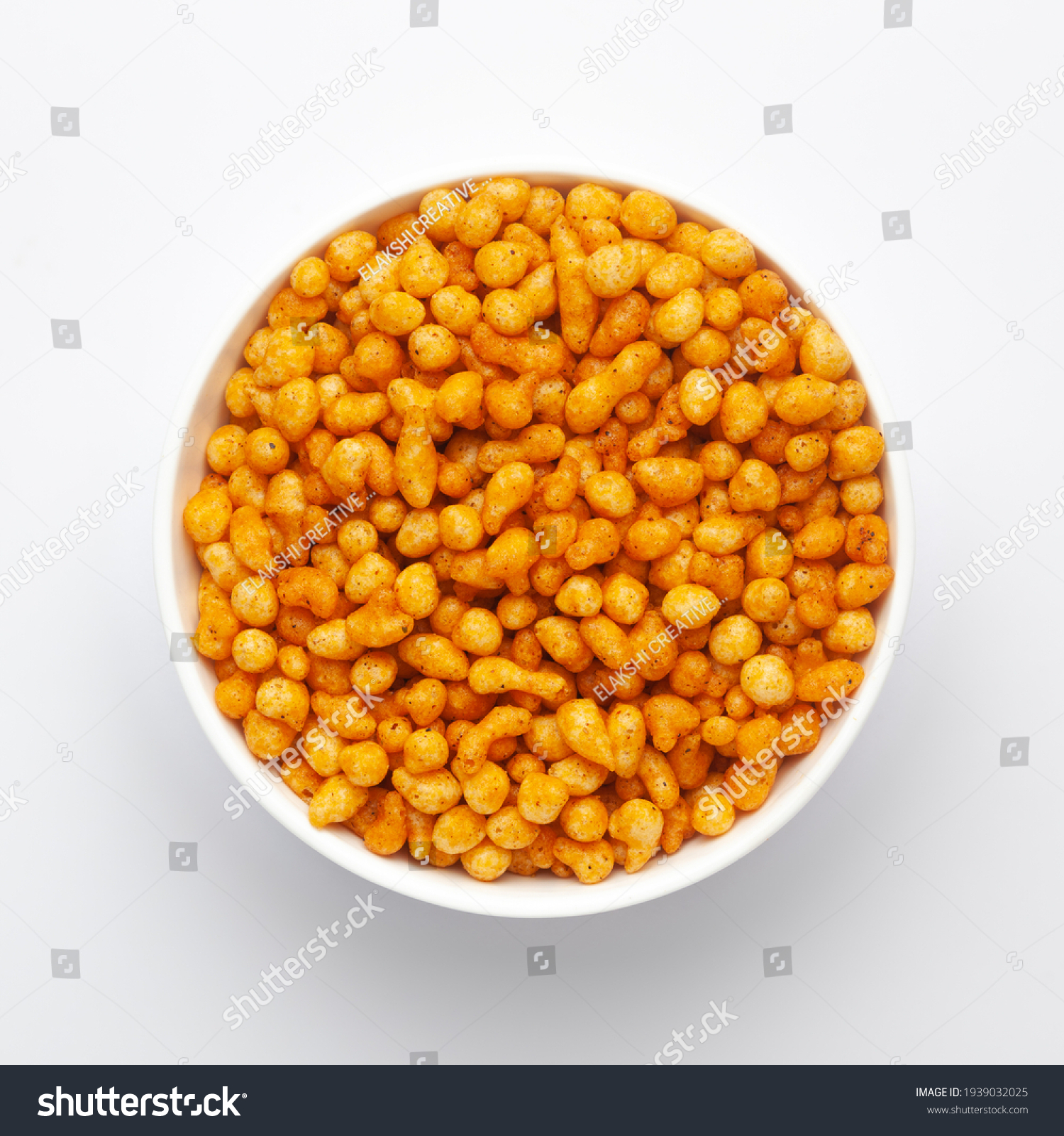 Close up of crunchy masala boondi Indian namkeen (snacks) on a ceramic white bowl. Top view #1939032025