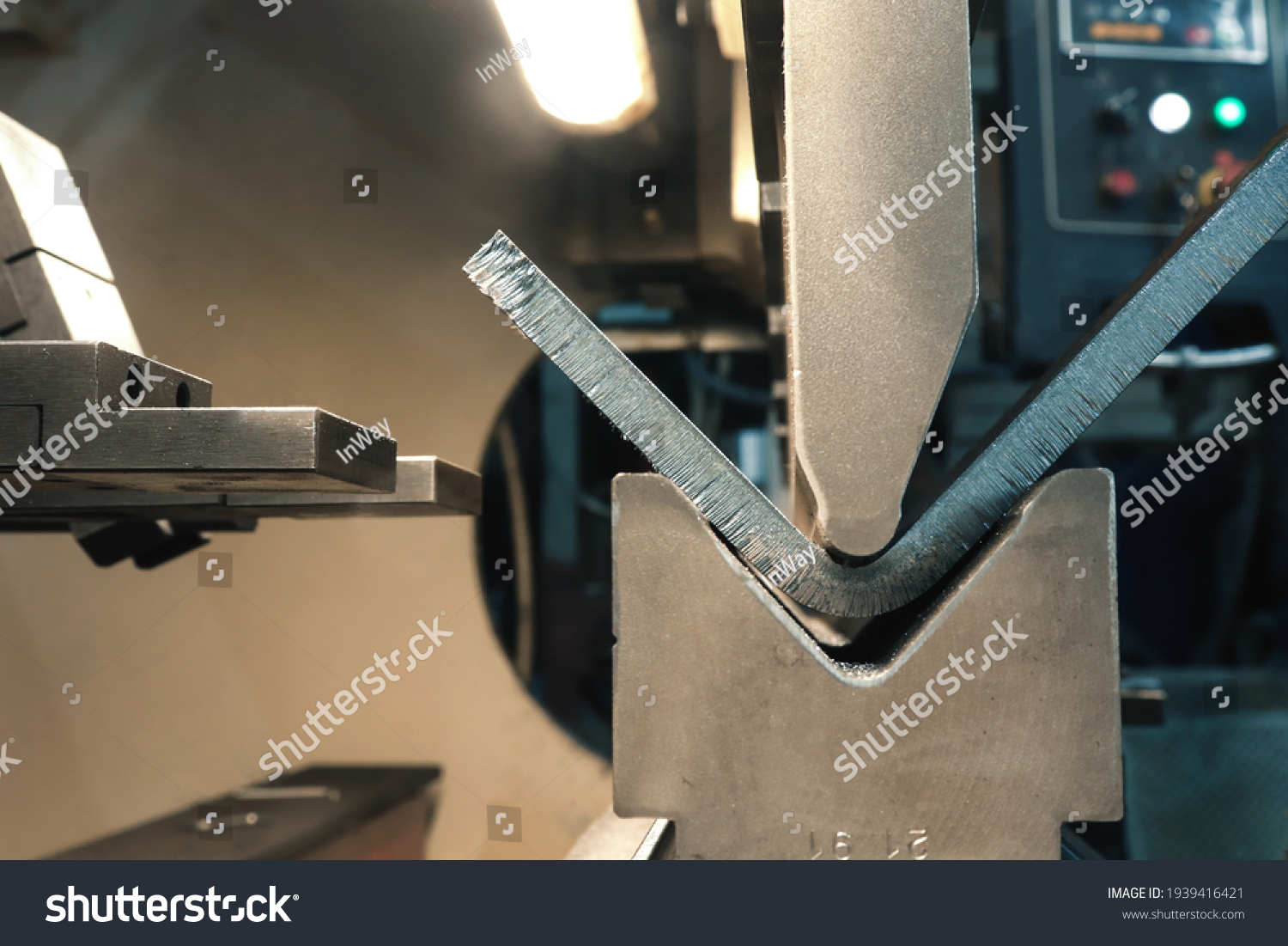 Metal bending. The process of metal bending on a CNC bending machine. Bending of metal using a v-shaped matrix and a punch.  #1939416421