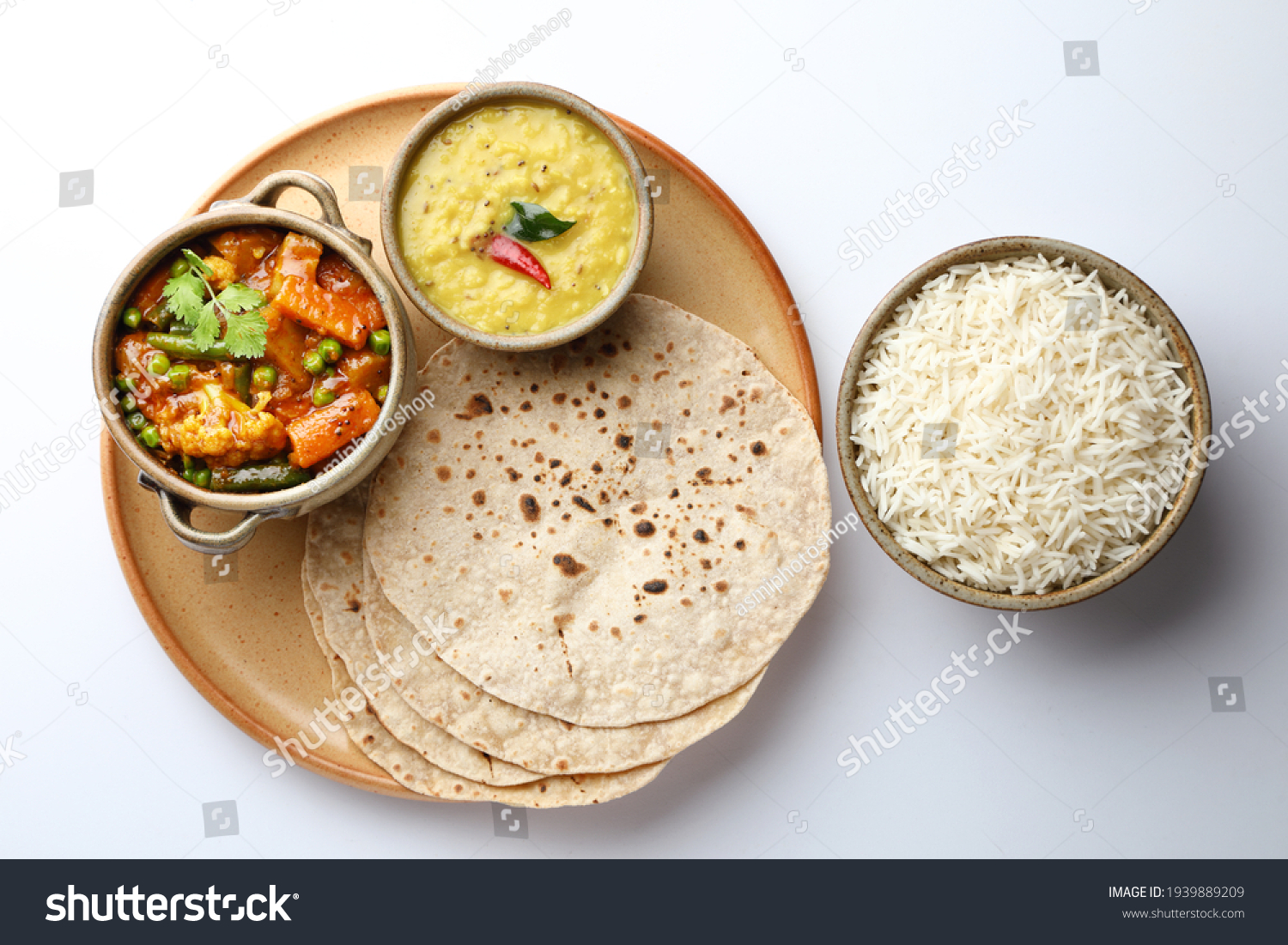 vegetarian Indian thali or Indian home food with lentil dal, cauliflower curry, roti or Indian flat bread and rice #1939889209