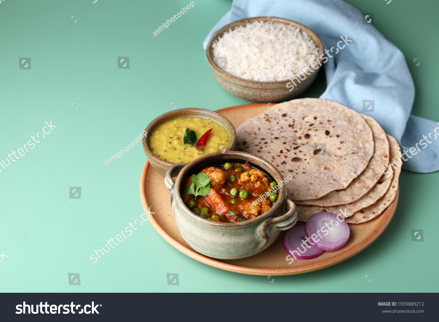 vegetarian Indian thali or Indian home food with lentil dal, cauliflower curry, roti or Indian flat bread and rice #1939889212