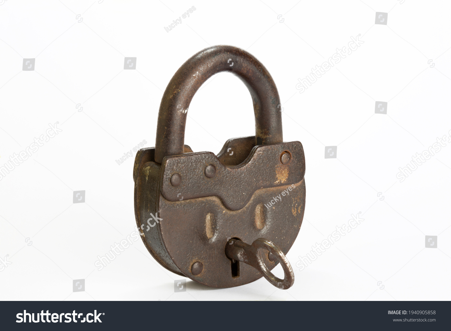 Vintage style copper lock and key isolated on white background. Antique objects. Horizontal close-up.  #1940905858