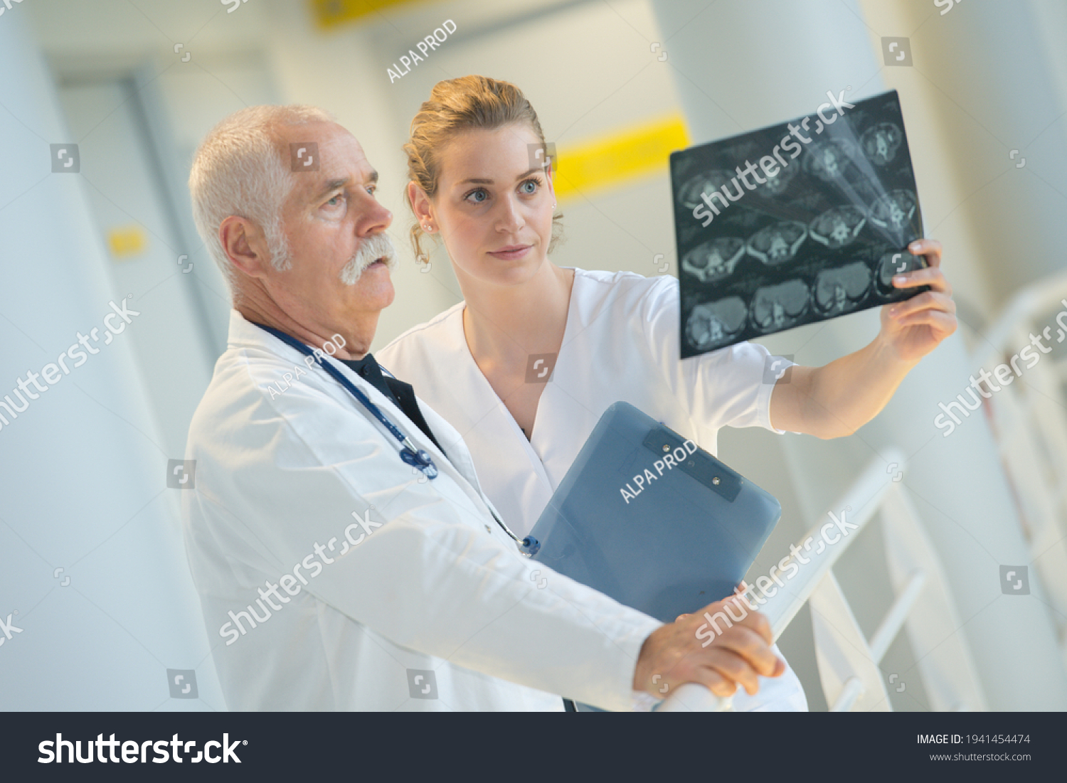 medic and assistant looking at x-ray #1941454474