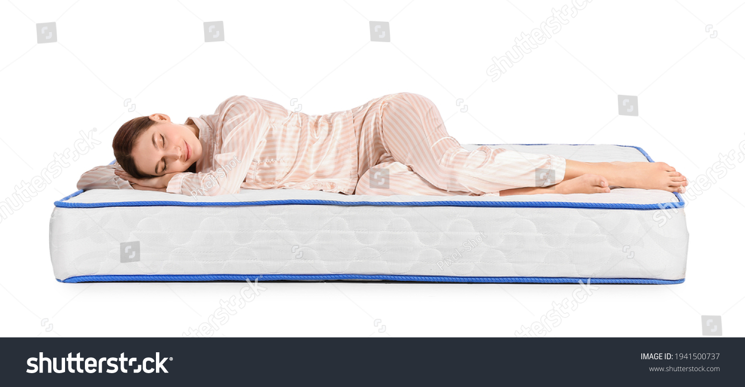 Young woman sleeping on mattress against white background #1941500737