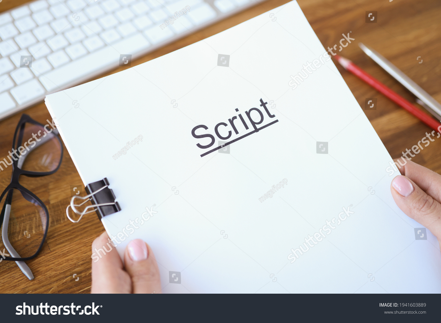 Female hands holding script over table closeup #1941603889