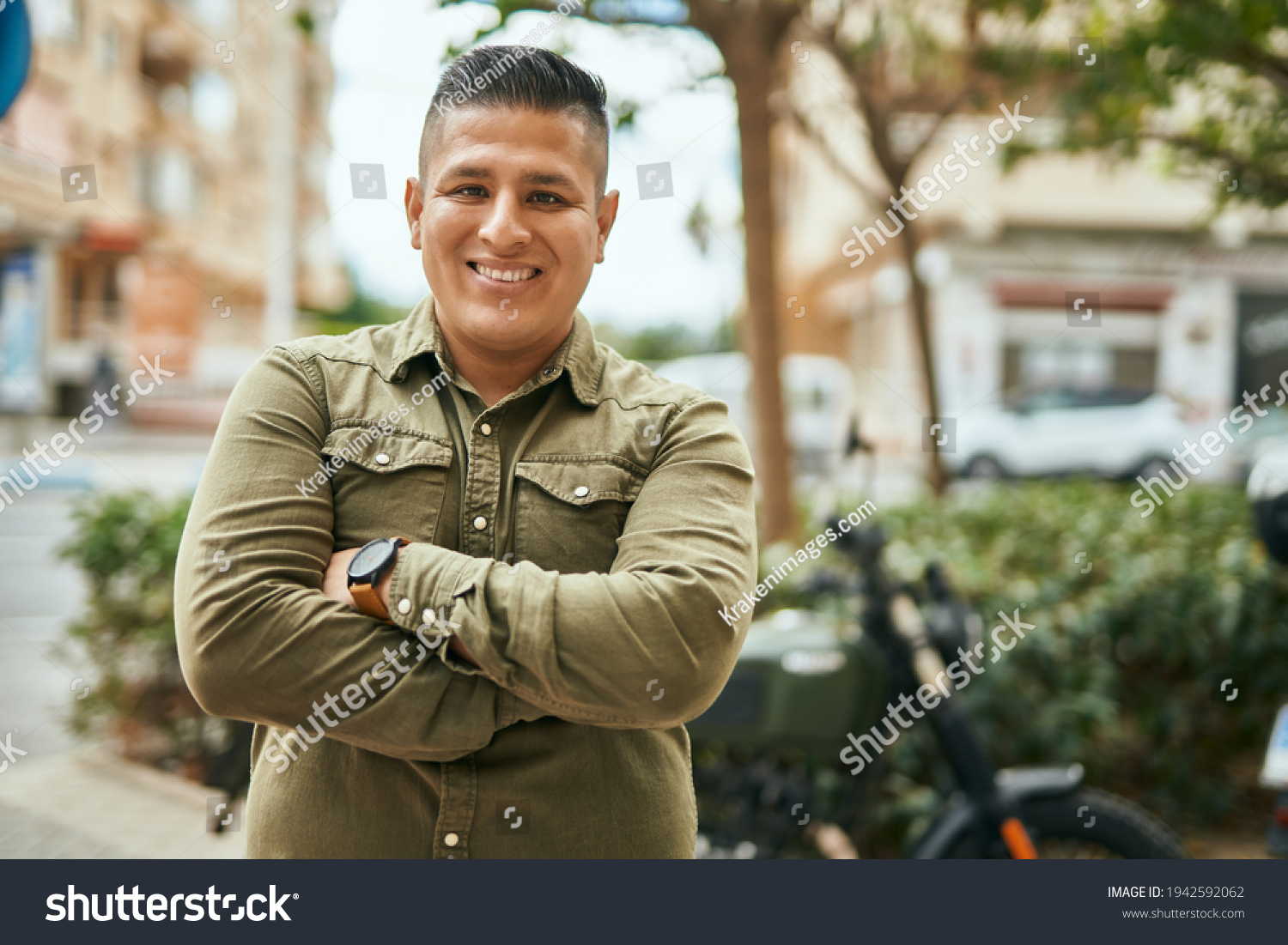 Young latin man with arms crossed smiling happy at the city. #1942592062