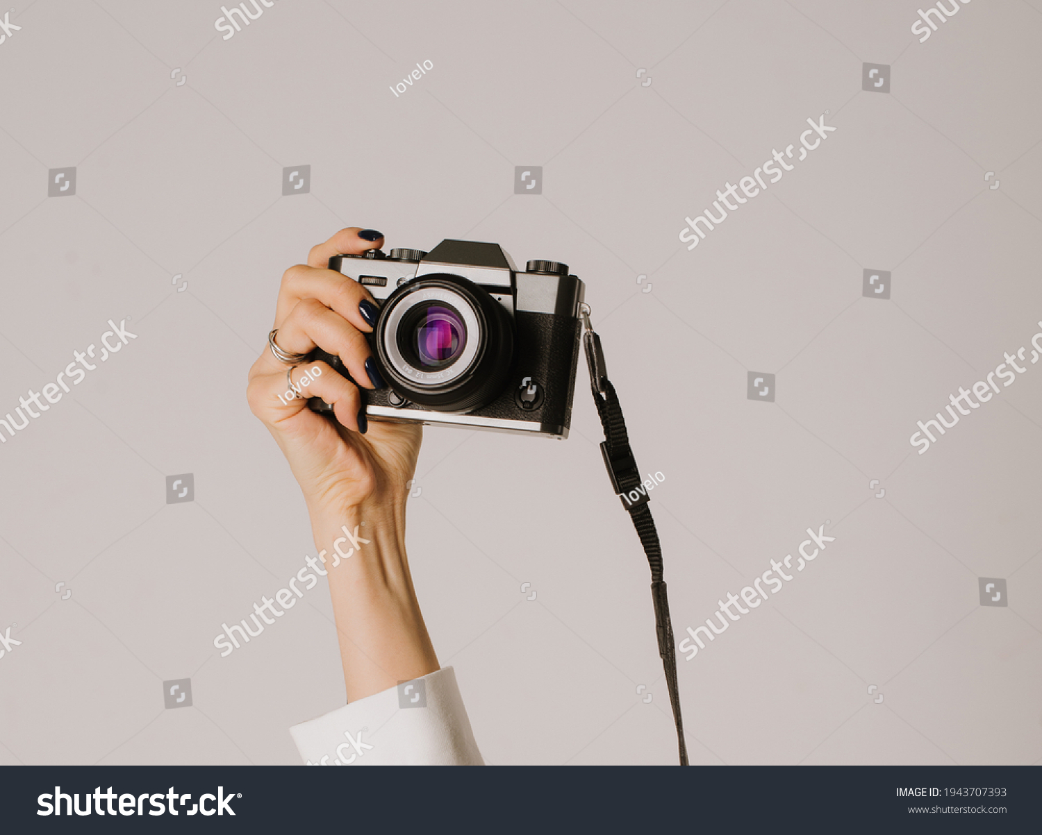 a camera in a woman's hands #1943707393