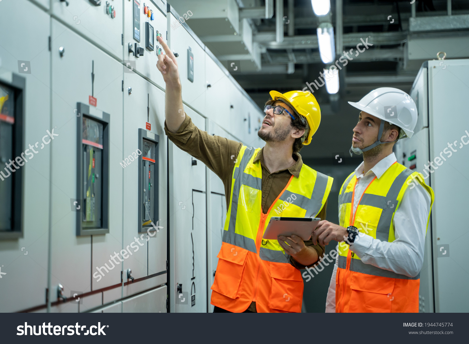 Engineer and technical worker working on the checking status switchgear electrical energy distribution substation at industry factory. #1944745774