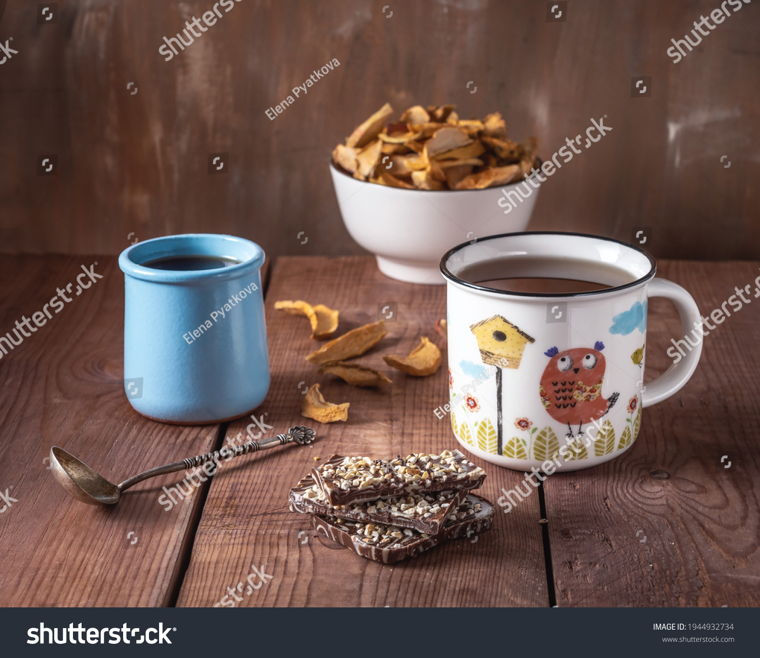Delicious sweet lunch with apple chis and apple syrup, tea in a large mug with a pattern on a wooden toe cap #1944932734