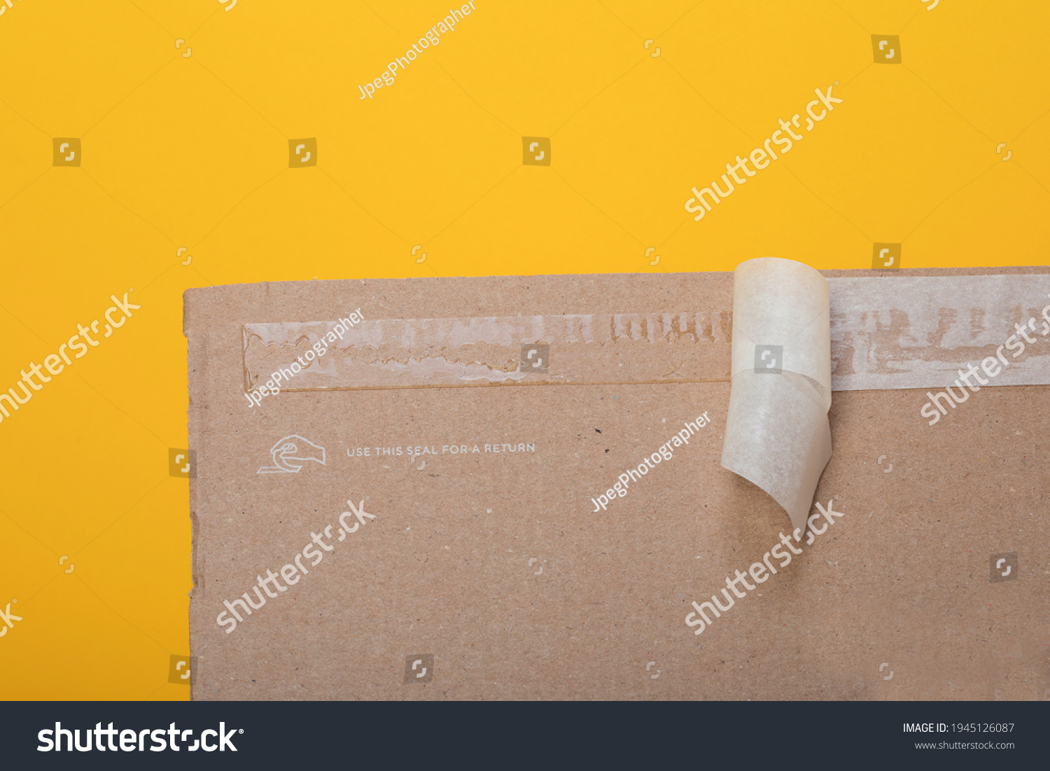 Resealable package for ecommerce products, fashion items returning. Sticky self adhesive sealing tape on corrugated cardboard box #1945126087