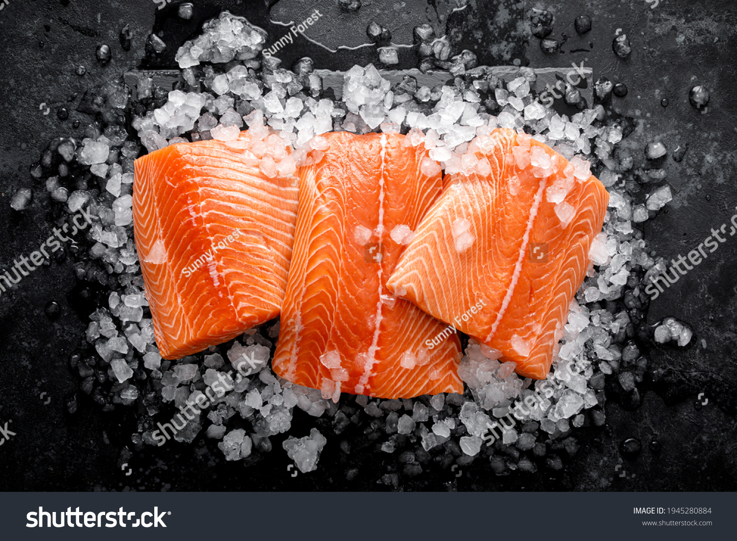 Salmon fillet. Slices of fresh raw salmon fish on ice #1945280884