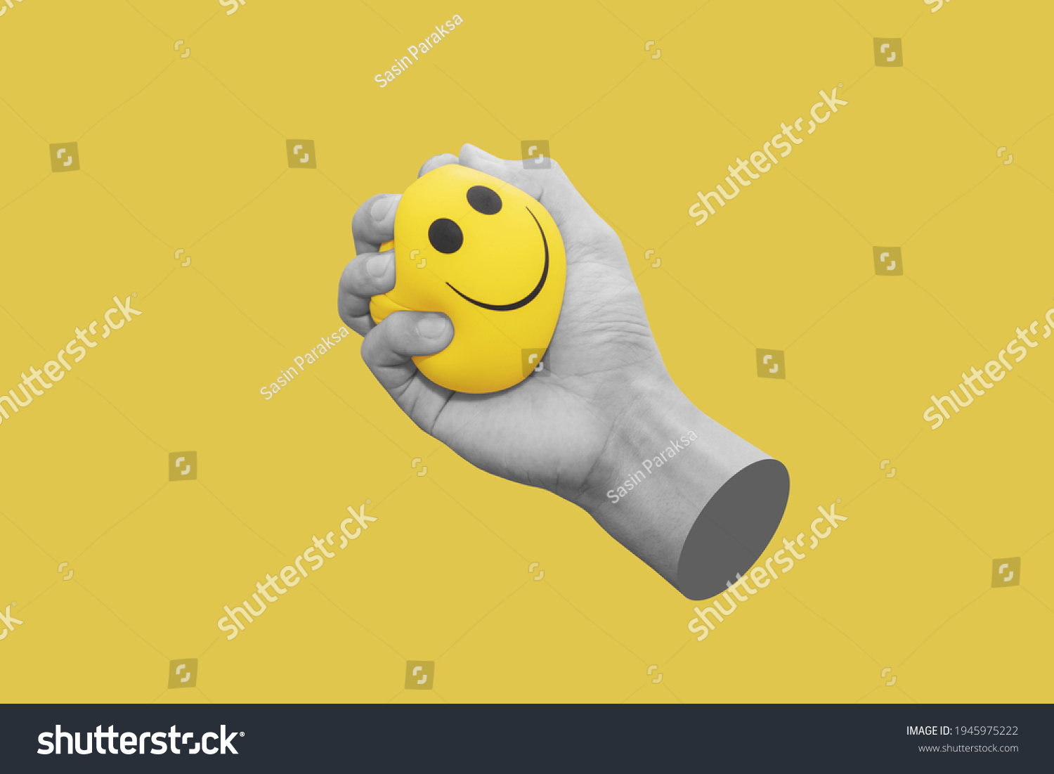 Hand squeeze yellow stress ball, isolated on yellow background #1945975222
