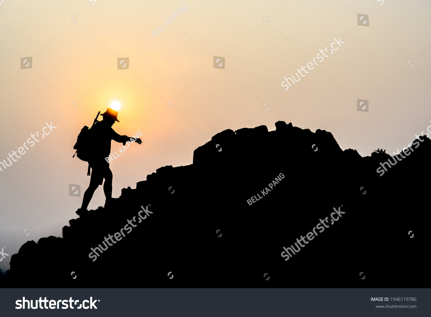 Young male tourists climbing mountains Ideas for personal development and goals in the life of a climber with a backpack. #1946119786
