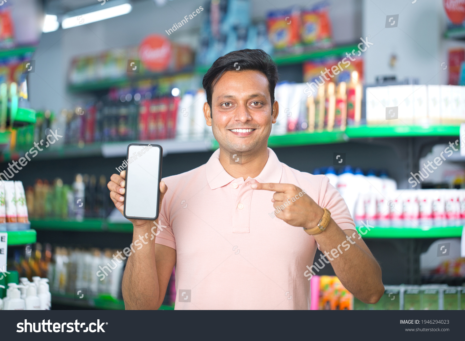 Man pointing at blank mobile phone screen in supermarket #1946294023