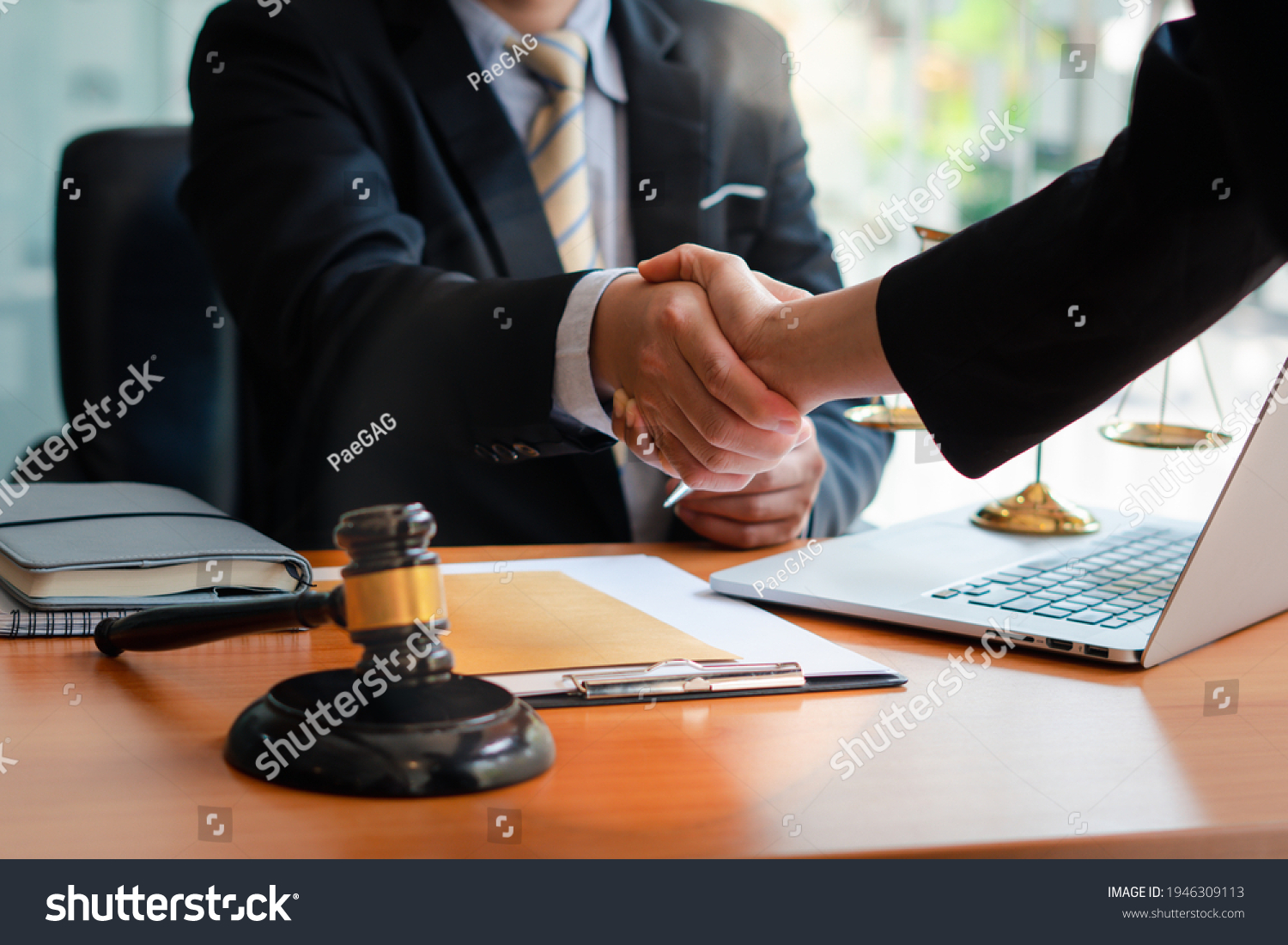 Businessman shaking hands to seal a deal with his partner
lawyers or attorneys discussing a contract agreement.Legal law, advice, and justice concept. #1946309113