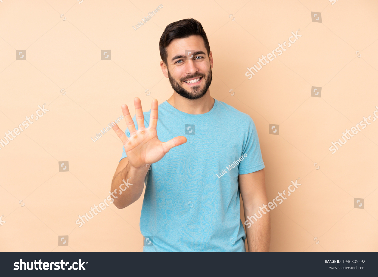 Caucasian handsome man isolated on beige background counting five with fingers #1946805592