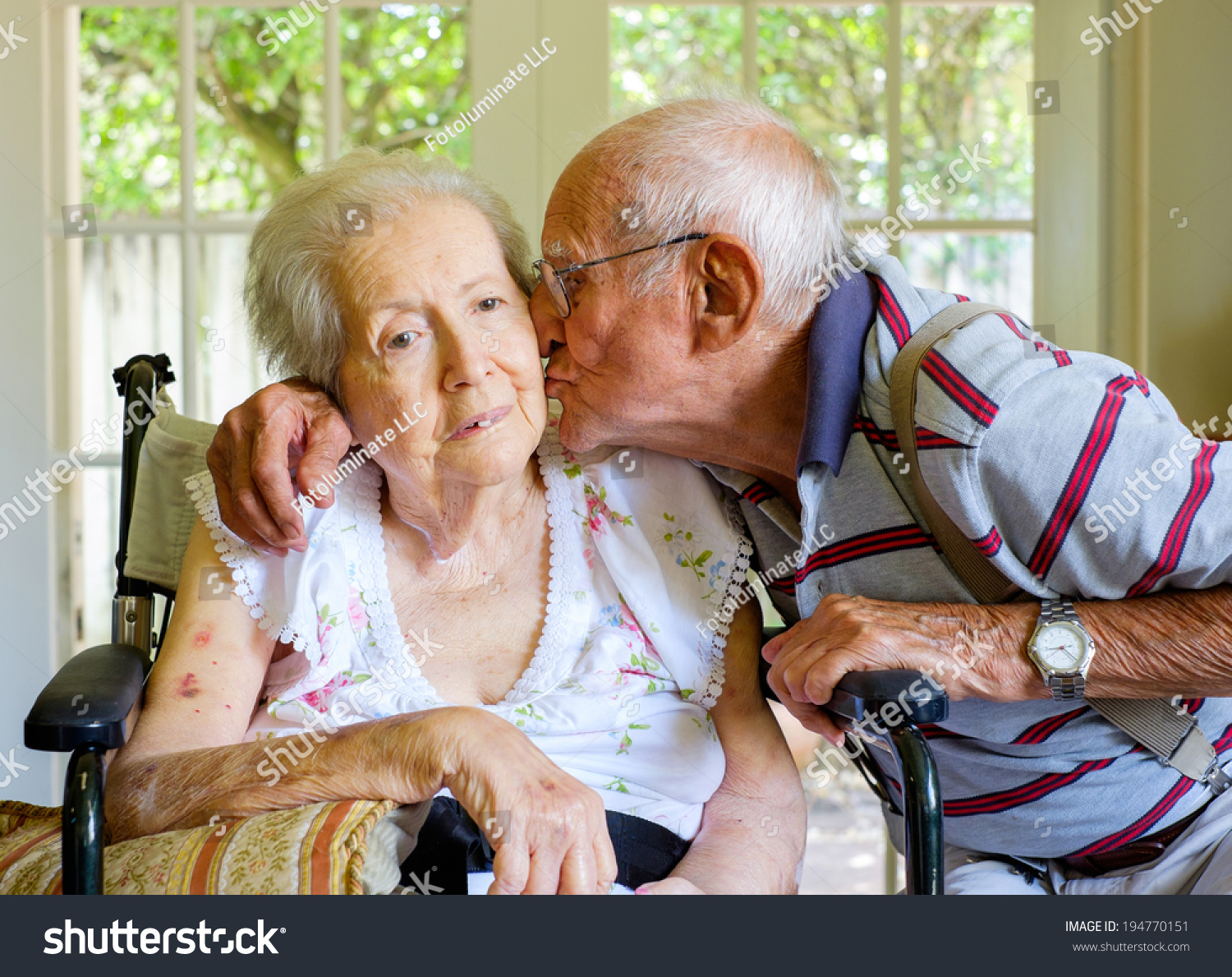 Elderly eighty plus year old woman in a wheel chair in a home setting with her husband. #194770151