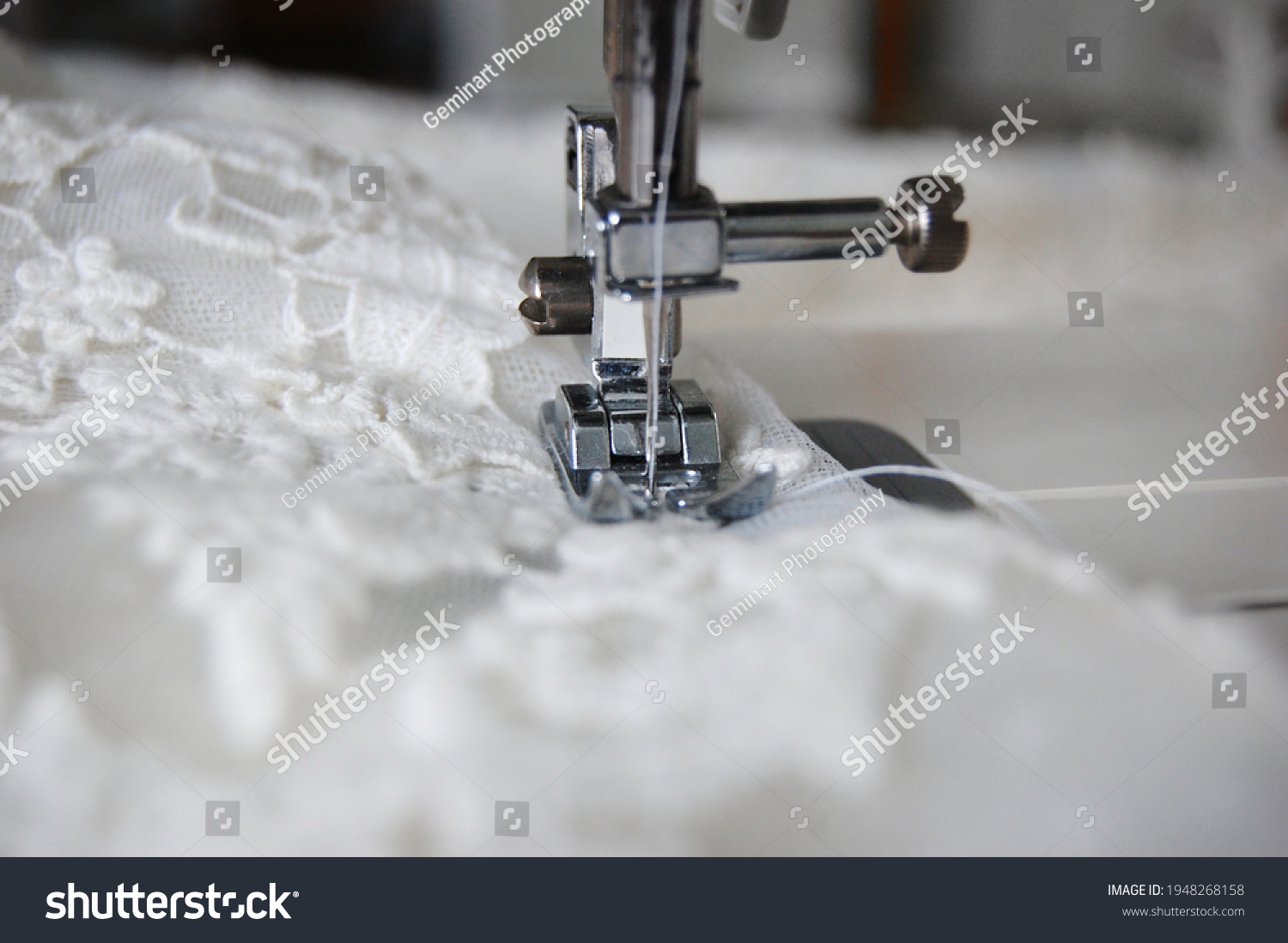 Close up of a sewing machine making alterations of a bride's wedding dress. #1948268158