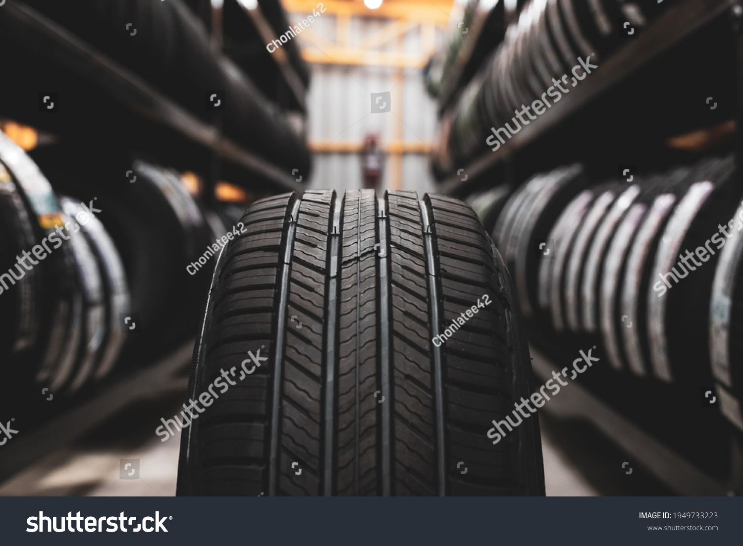 A new tire is placed on the tire storage rack in the car workshop. Be prepared for vehicles that need to change tires. #1949733223