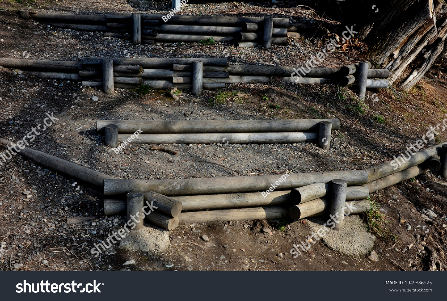 stair construction made of wooden poles used as palisades. a wooden staircase leading down the slope to the water is an anti-erosion element in the landscape #1949886925