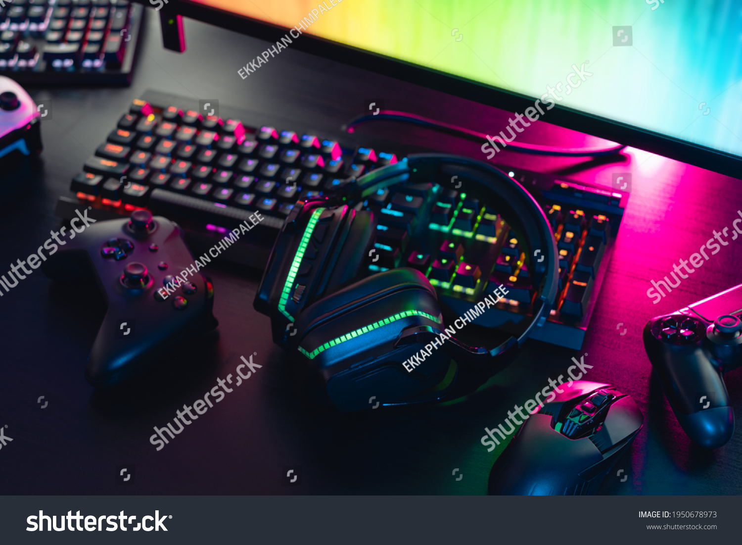 gamer work space concept, top view a gaming gear, mouse, keyboard, joystick, headset with rgb color on black table background. #1950678973